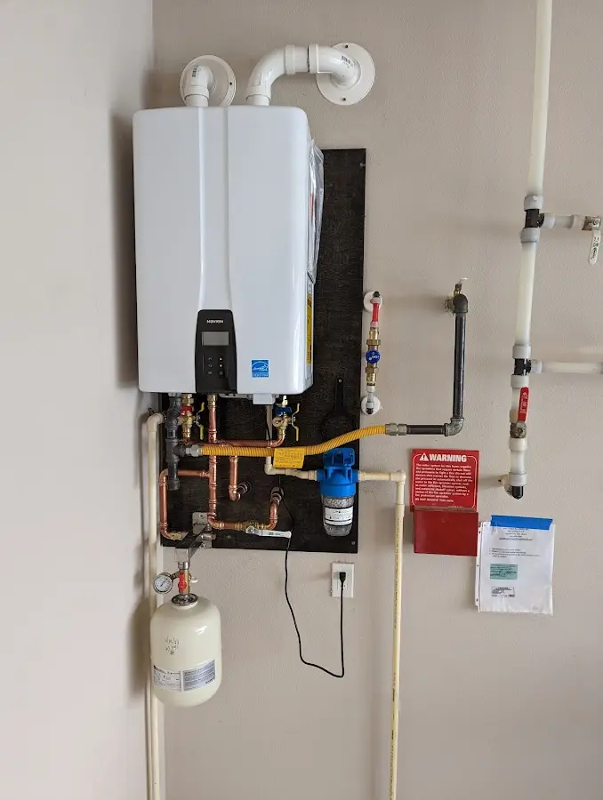 Professional plumber installing copper piping in a Peppermill Village home